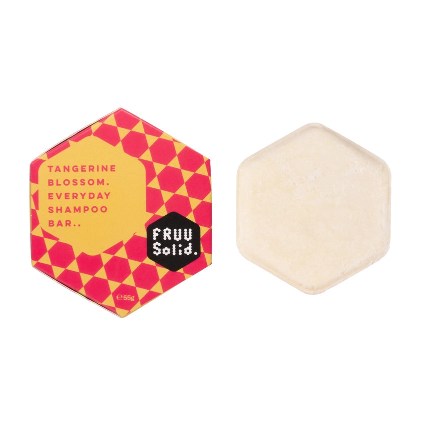 The orange shampoo bar on the right and its hexagonal box on the left