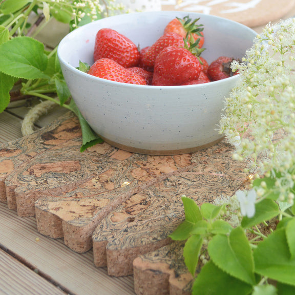 Shown with a bowl of strawberries on top