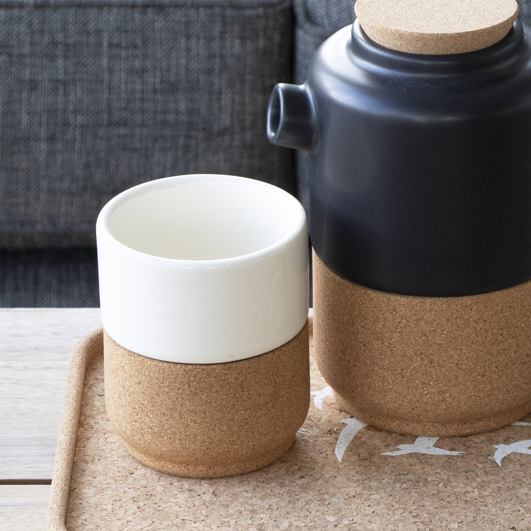 The mug shown next to a matching teapot in black