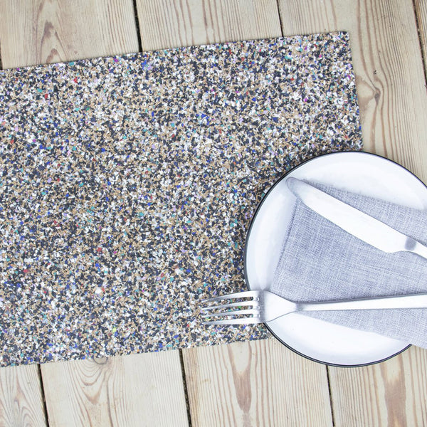 Recycled plastic and cork placemat shown from above next to a side plate
