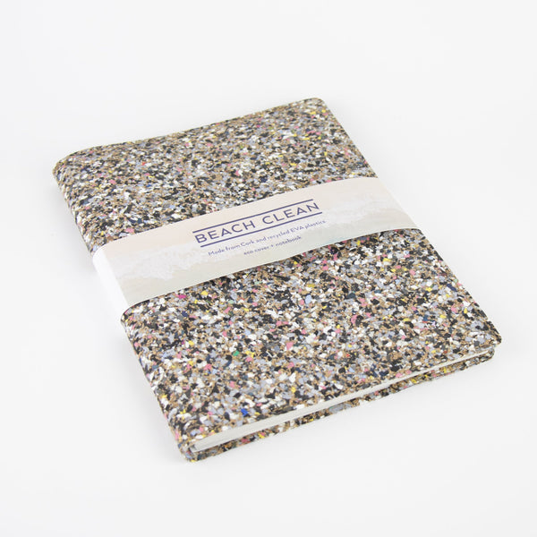 Refillable notebook laid flat with cardboard bellyband