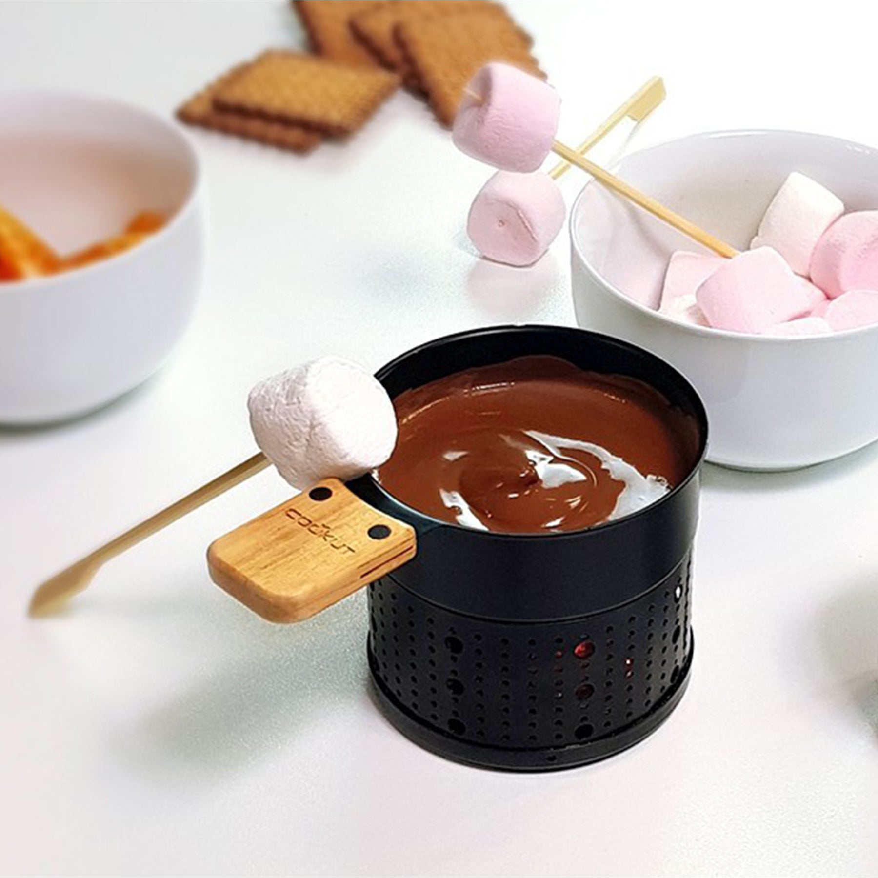 Dipping marshmallows in the mini chocolate fondue set