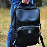 Man holding the upcycled backpack by the top carry handle