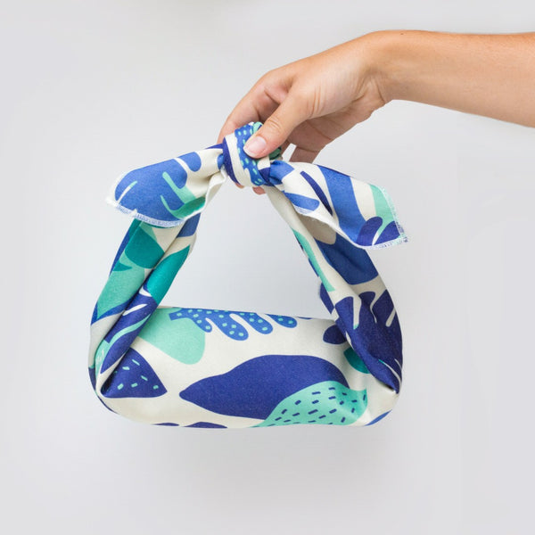 Blue leafy furoshiki wrapping a water bottle