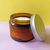 Reusable makeup remover pads in an amber glass storage jar