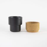 Black handleless mug with ceramic and cork parts separated