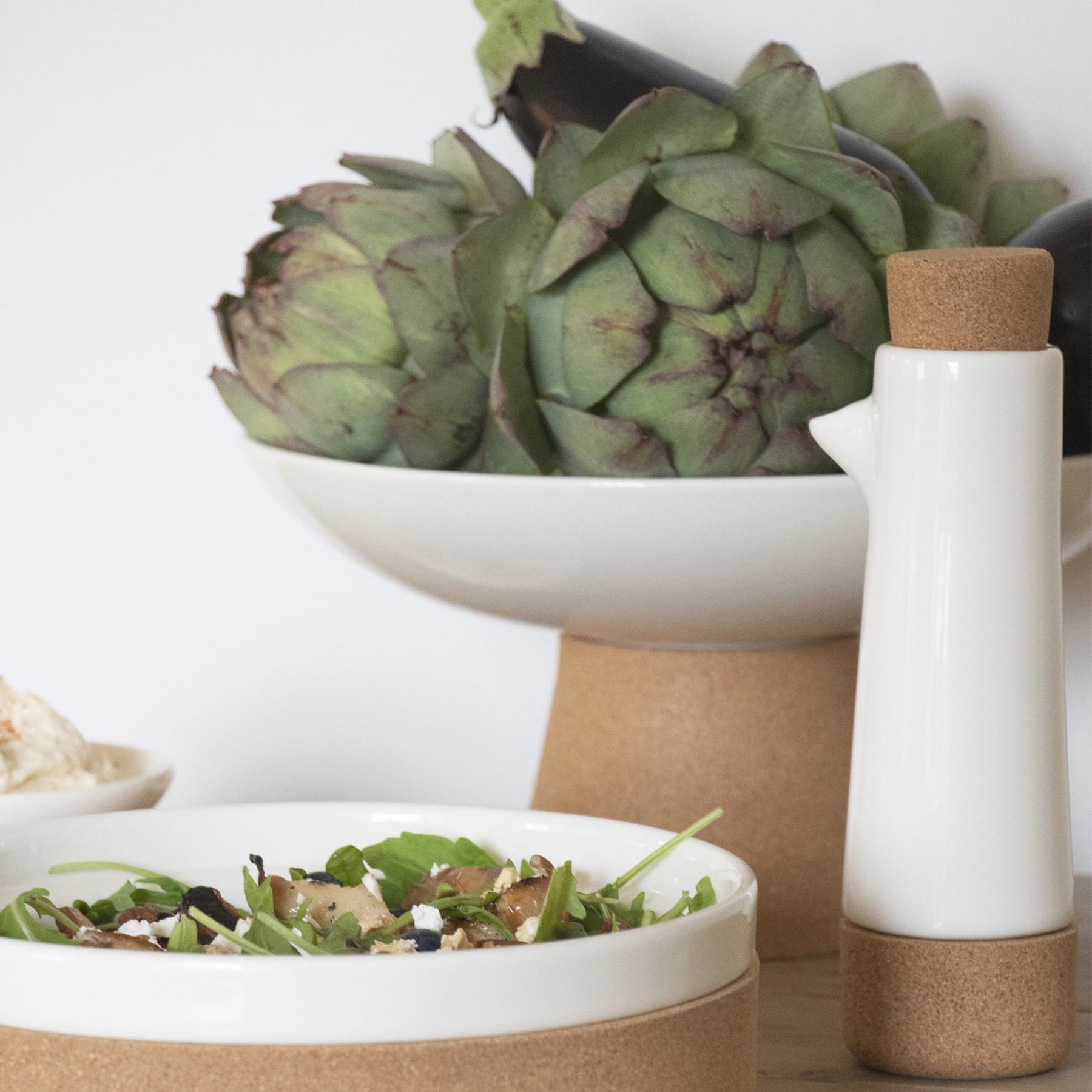 white ceramic and cork fruitbowl with matching tableware